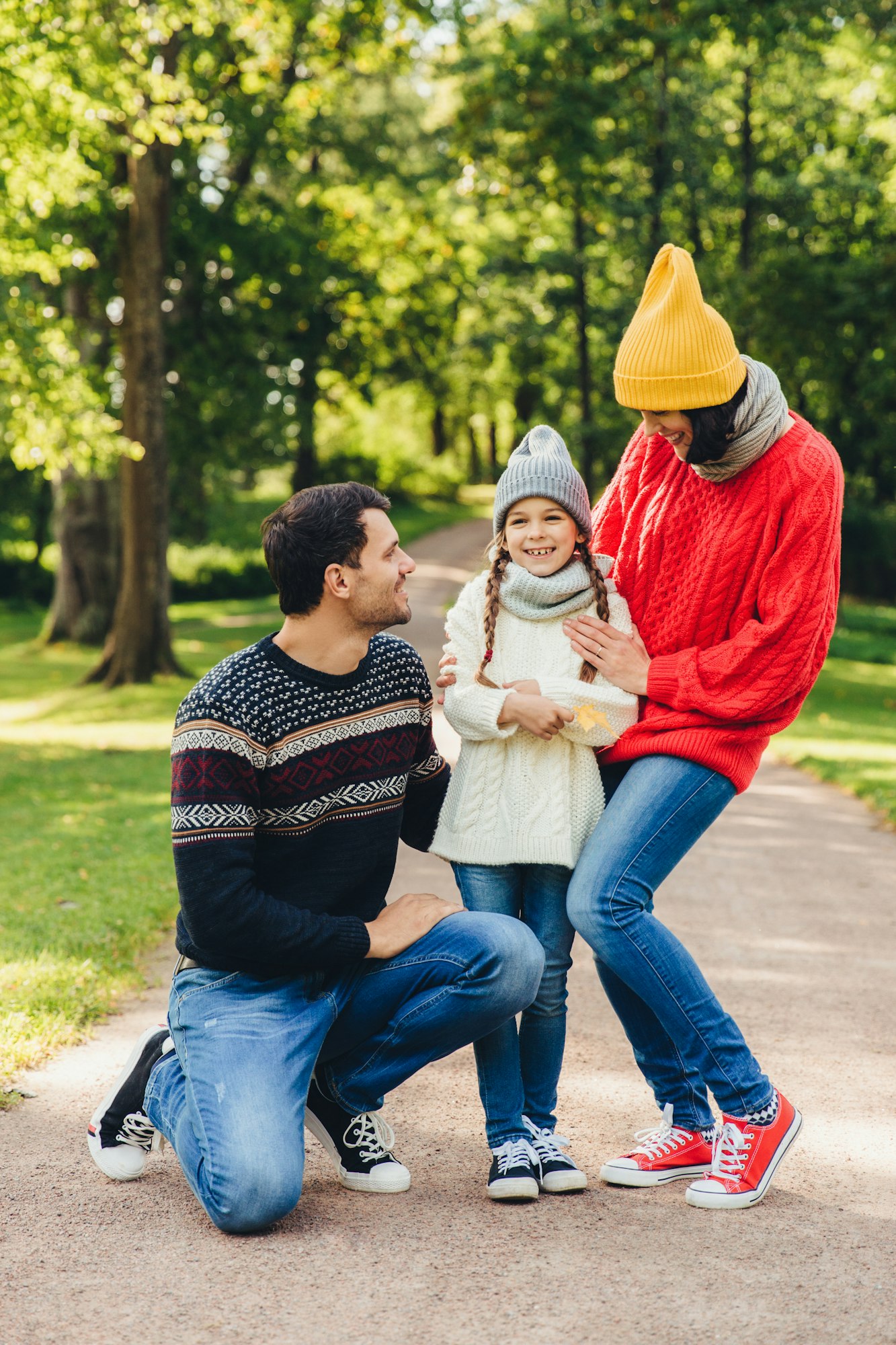 Adorable small cute child being glad to be supported by parents.